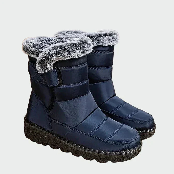 A woman on a frosty morning wearing warm deep navy winter boots with a grippy sole.