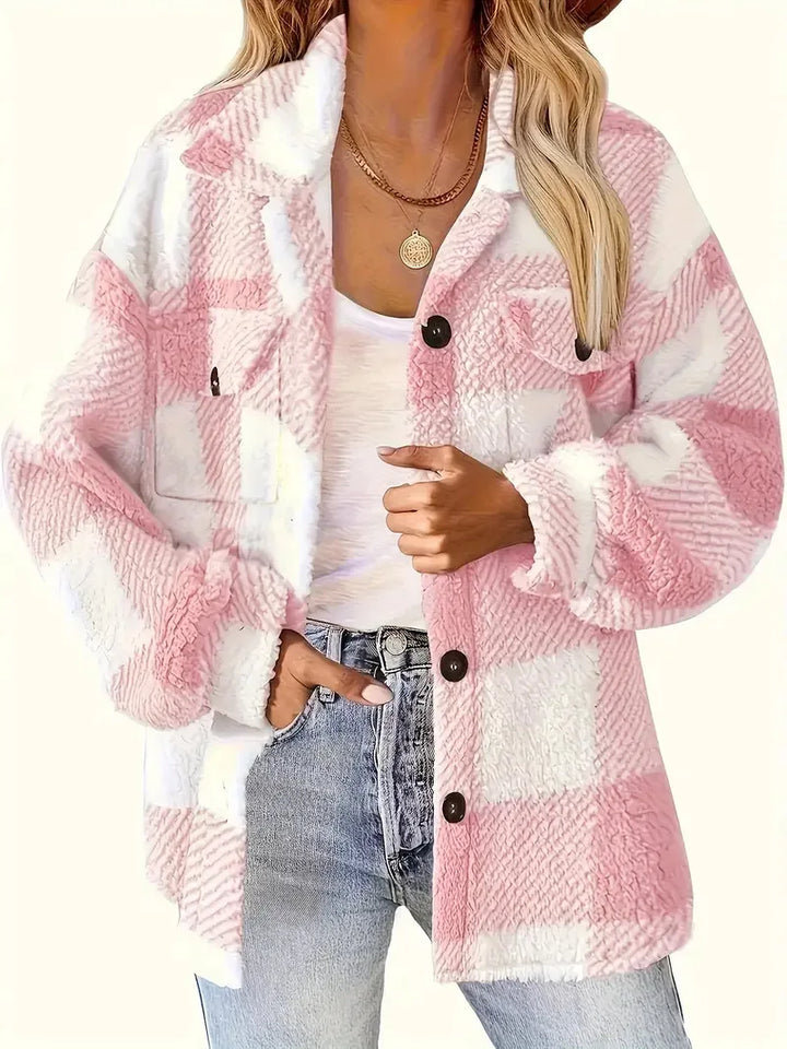 A woman wearing a soft checked jacket over casual clothes on a cool fall morning.
