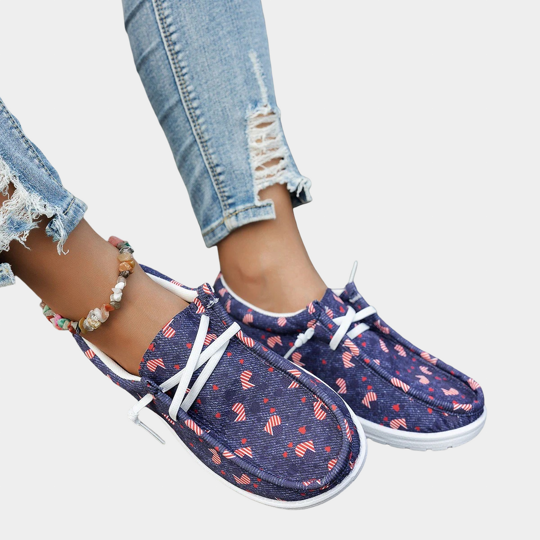 A woman wearing navy heart-print lace-up comfort shoes on a walk.