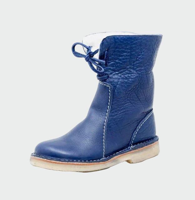 Woman wearing beige warm-lined winter boots on a cold day out.