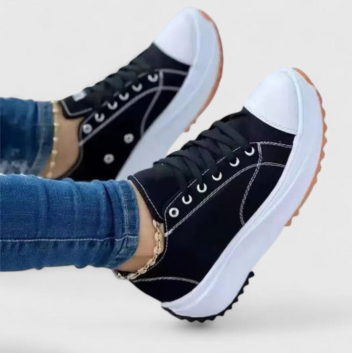 A woman in bold lace-up platform comfort sneakers styled with jeans.