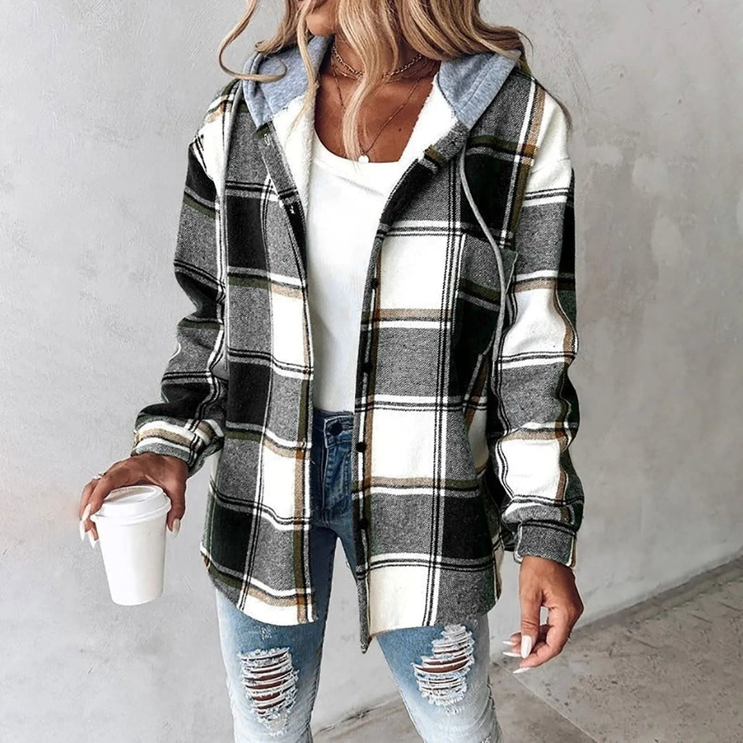A woman wearing a grey and white checked hooded jacket with a button front