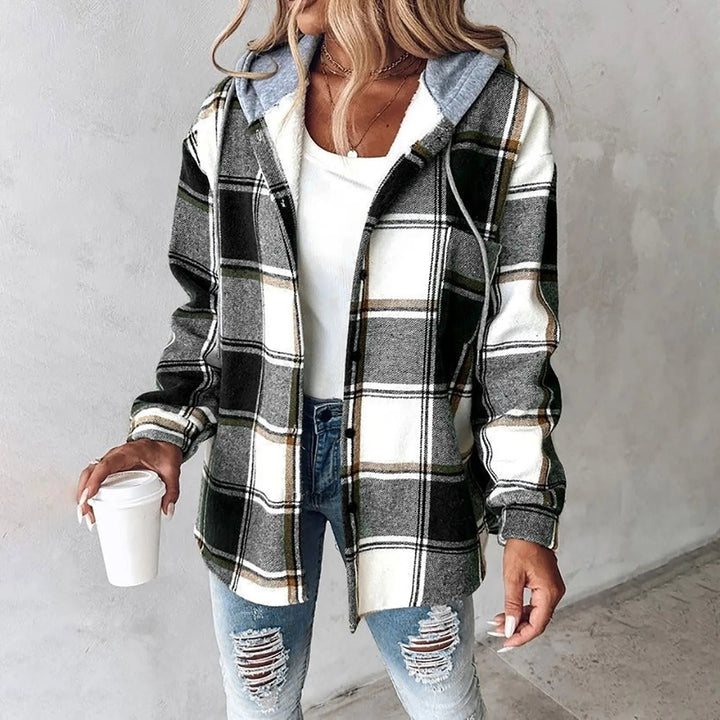 A woman wearing a grey and white checked hooded jacket with a button front