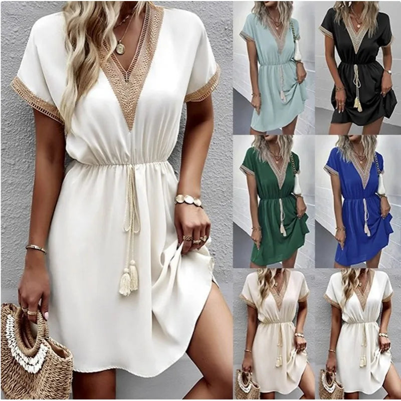 A woman wearing a relaxed boho dress with fringe accents and delicate openwork detailing.