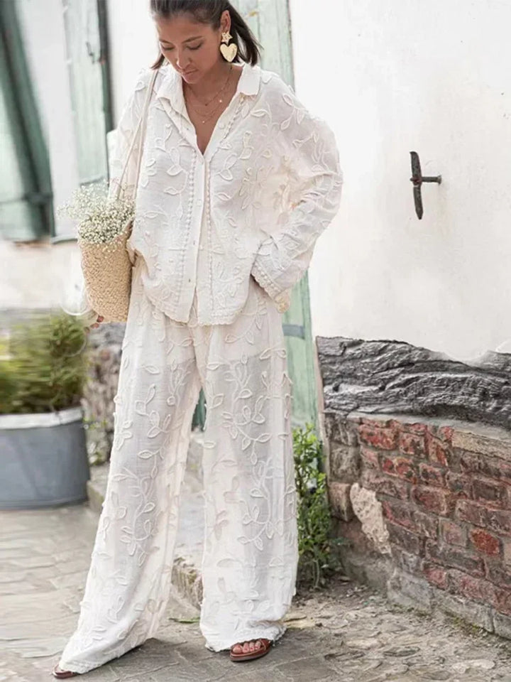A woman wearing an embroidered relaxed two-piece set with wide pants