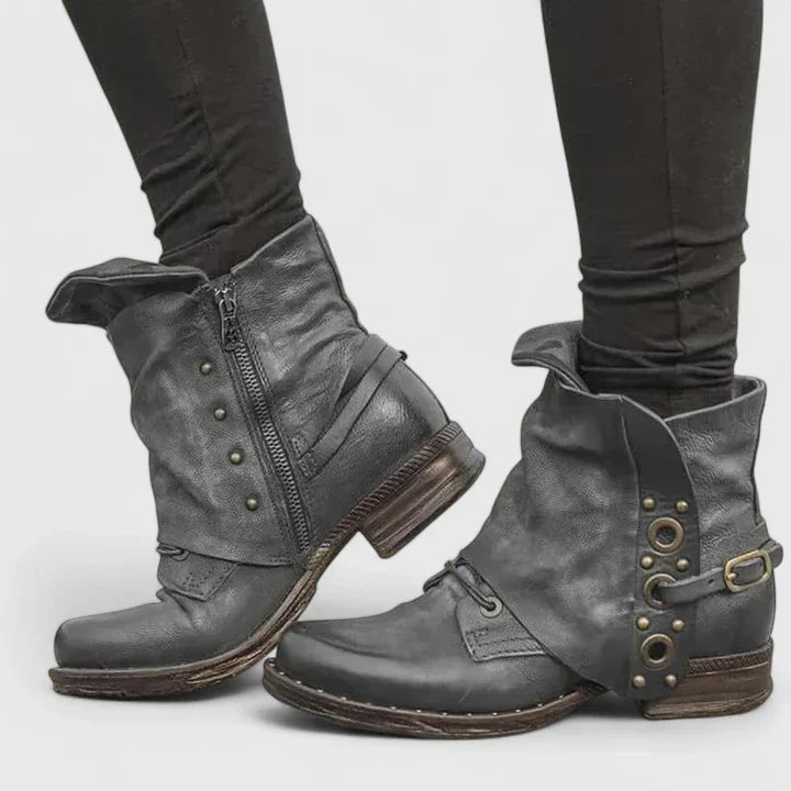 Woman wearing grey supportive ankle boots, walking confidently through town.