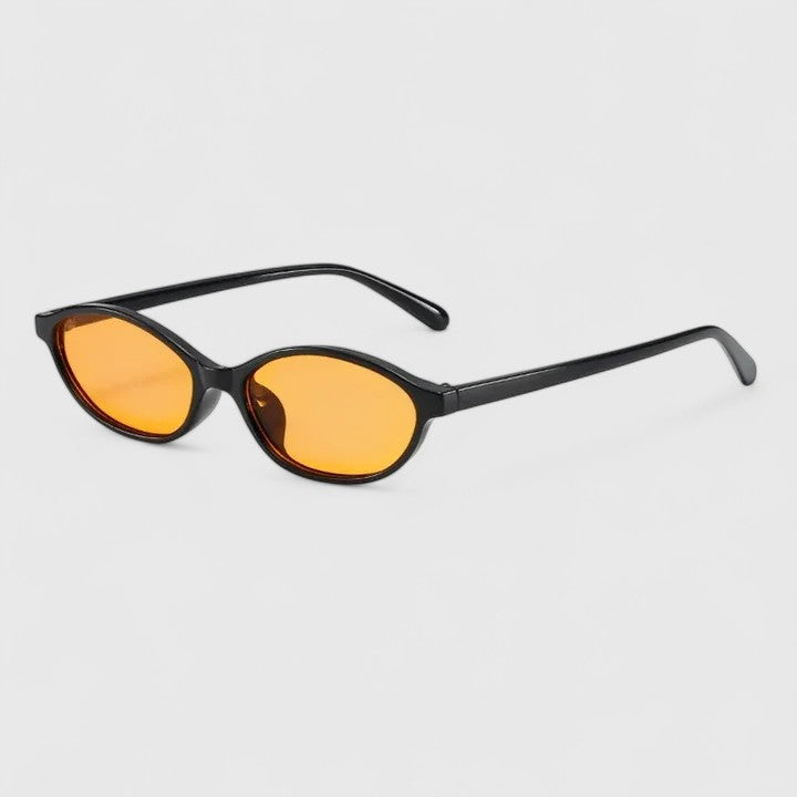 A woman wearing retro oval cat-eye sunglasses on a sunny afternoon.