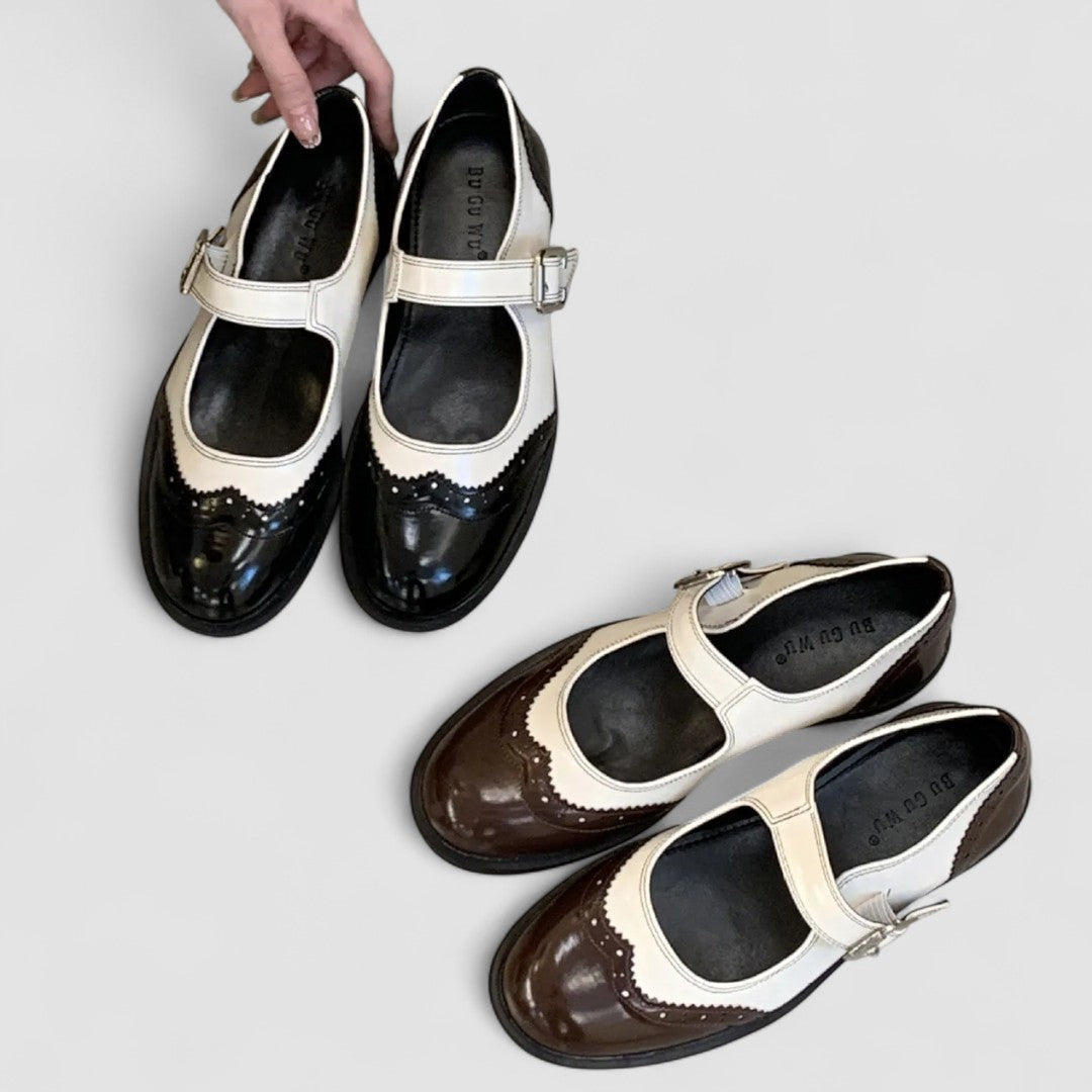 A woman wearing two-tone black and cream Mary Jane shoes, steady and comfortable on an evening out.