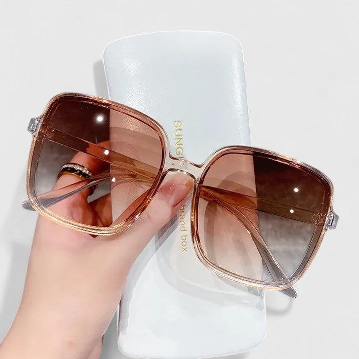 A woman running errands in town wearing classic square sunglasses, calm and stylish.