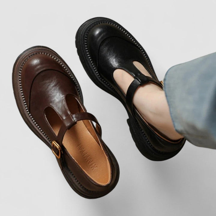 A woman wearing brown T-strap Mary Jane shoes, comfortable on a day around town.