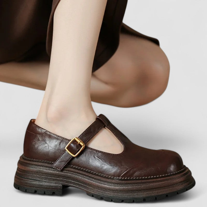 A woman wearing brown T-strap Mary Jane shoes, comfortable on a day around town.