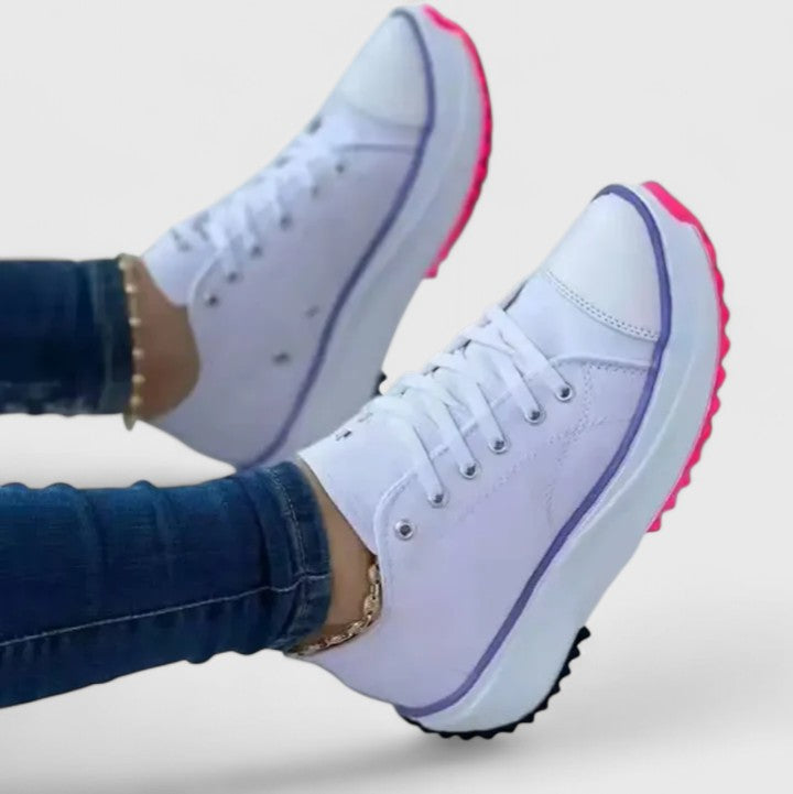 A woman in bold lace-up platform comfort sneakers styled with jeans.