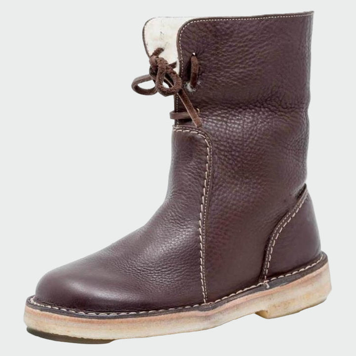 Woman wearing beige warm-lined winter boots on a cold day out.