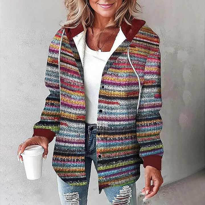 A woman wearing a grey and white checked hooded jacket with a button front