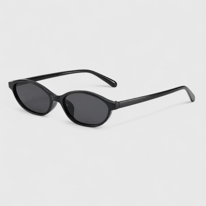 A woman wearing retro oval cat-eye sunglasses on a sunny afternoon.