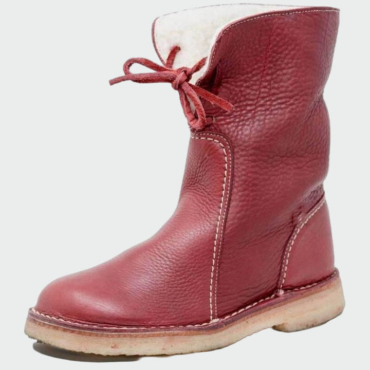 Woman wearing beige warm-lined winter boots on a cold day out.