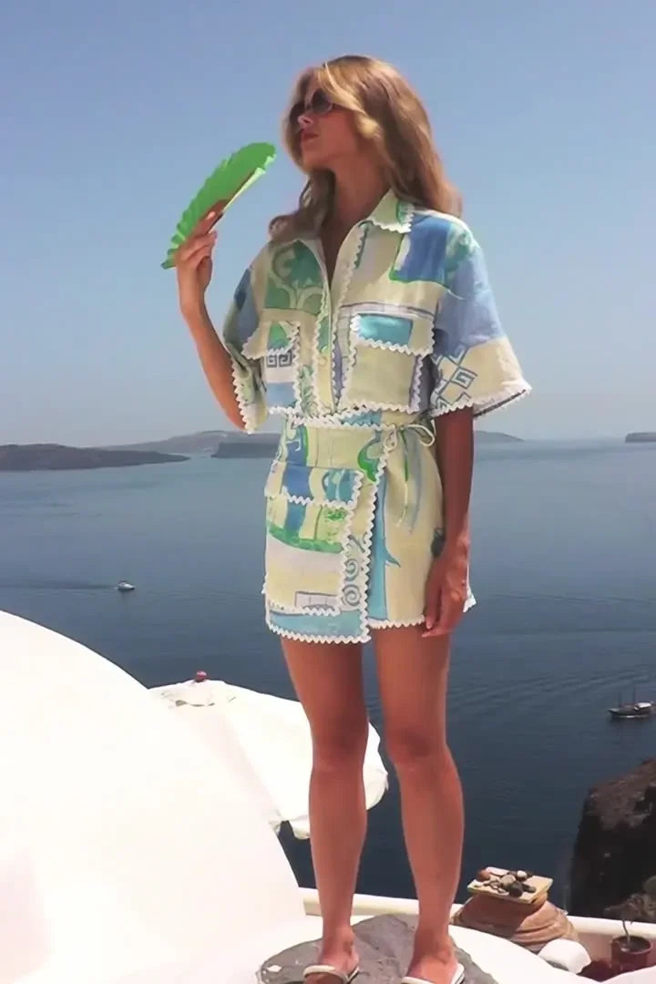 A woman wearing a patchwork print short-sleeve top and matching tie-waist shorts on a sunny day