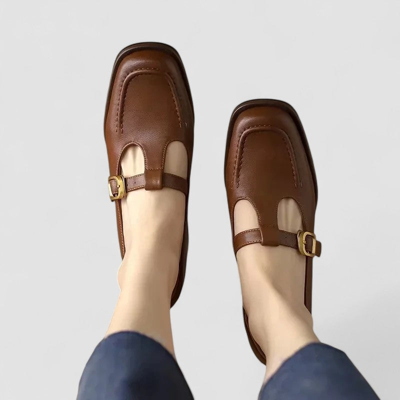 A woman wearing brown T-strap Mary Jane shoes, steady and comfortable through the day.
