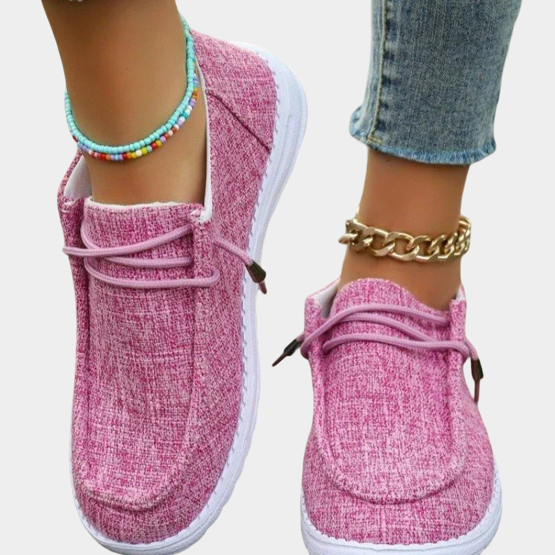 A woman wearing soft pink lace-up comfort shoes on a spring day.