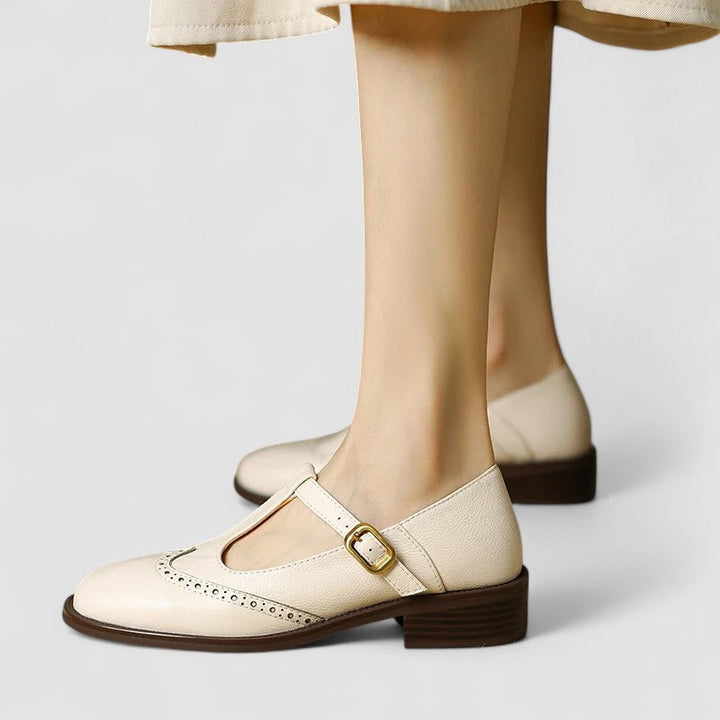A woman in beige T-strap Mary Jane shoes, comfortable and balanced on a busy day.