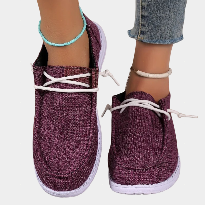 A woman wearing wine red lace-up comfort shoes on an fall walk.