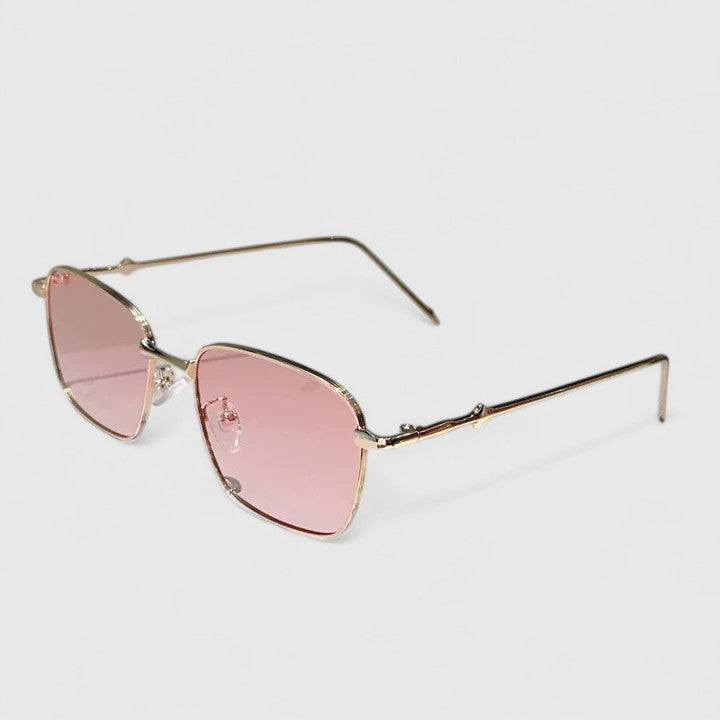 A woman on a sunny street wearing classic square gradient sunglasses, confident and stylish.