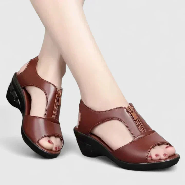 Black peep-toe sandals with a buckled instep strap and a sturdy block heel.