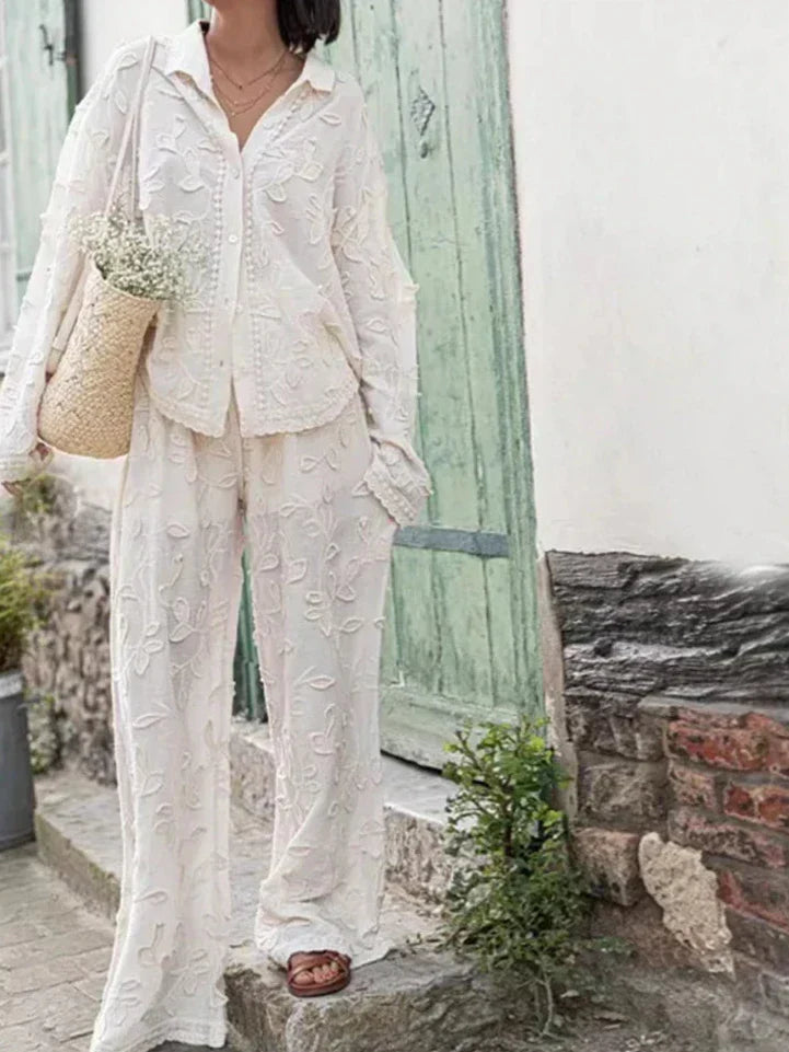 A woman wearing an embroidered relaxed two-piece set with wide pants