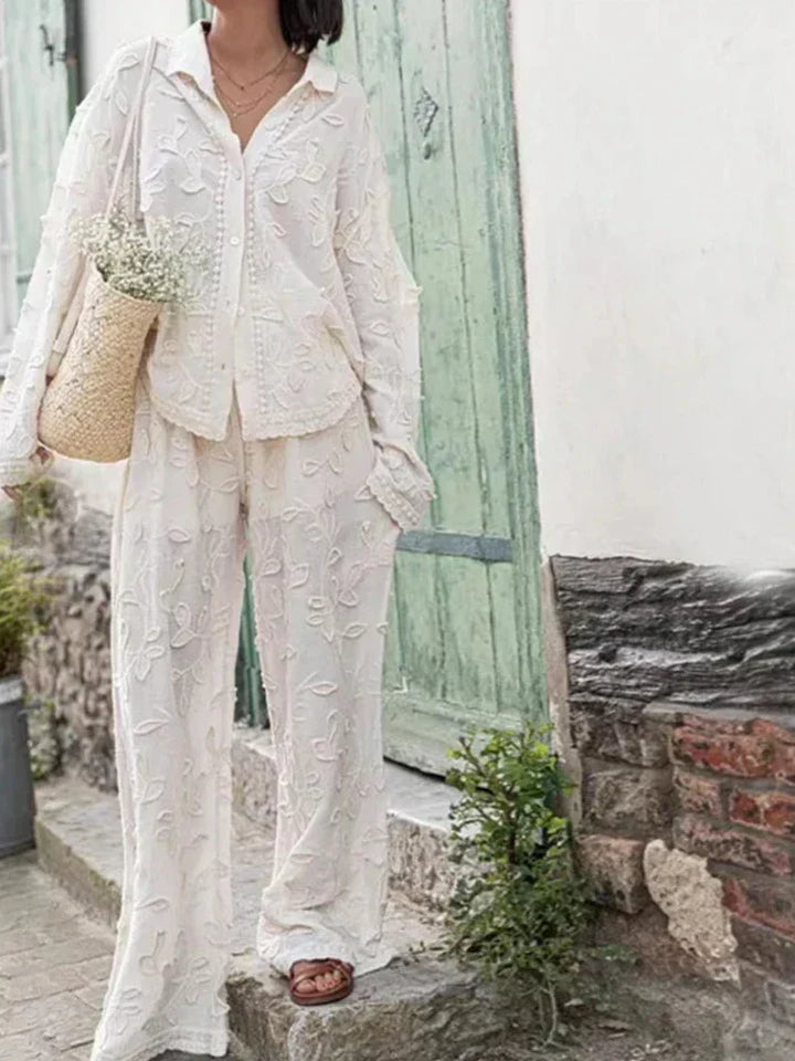 A woman wearing an embroidered relaxed two-piece set with wide pants