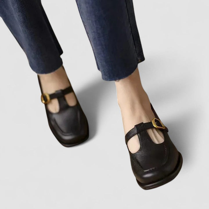 A woman wearing brown T-strap Mary Jane shoes, steady and comfortable through the day.