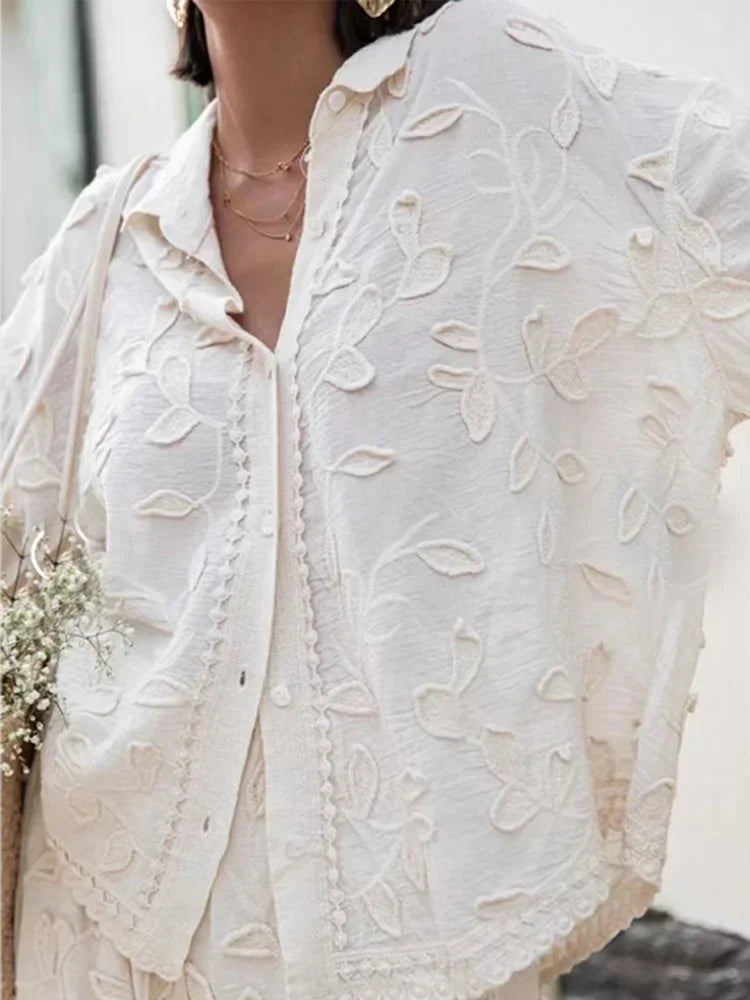 A woman wearing an embroidered relaxed two-piece set with wide pants