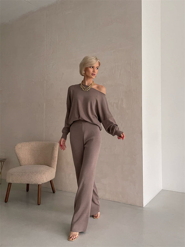 A woman wearing an off-shoulder draped top with wide-leg pants