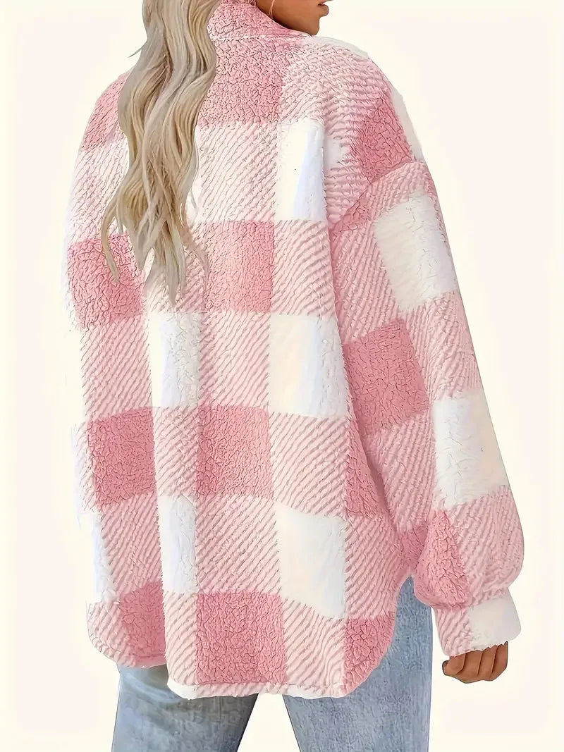A woman wearing a soft checked jacket over casual clothes on a cool fall morning.
