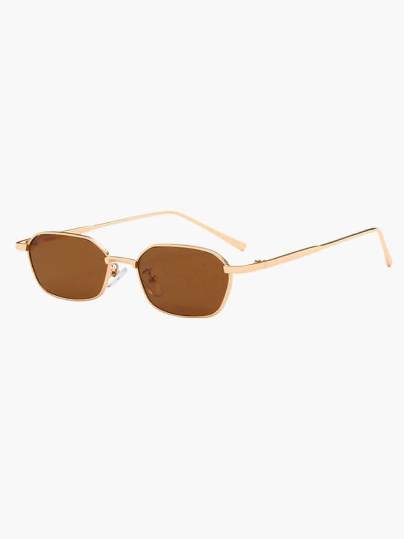 A woman wearing vintage-style gold polarised sunglasses on a sunny day out.