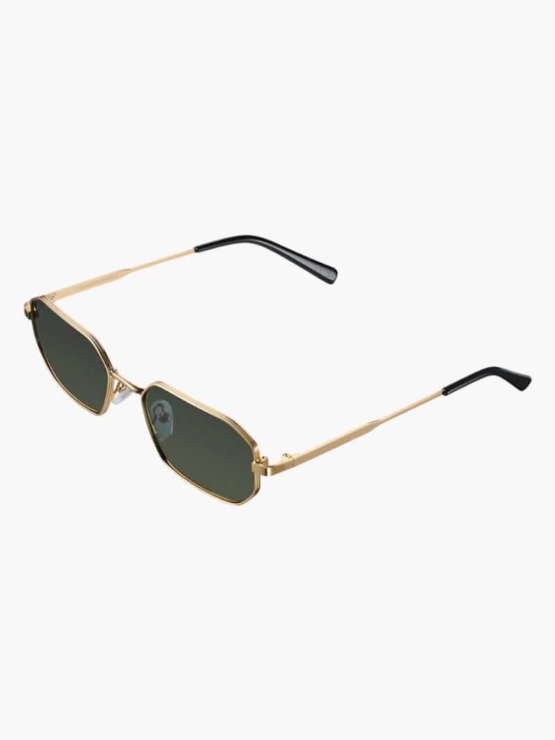 A woman wearing vintage-style gold polarised sunglasses on a sunny day out.