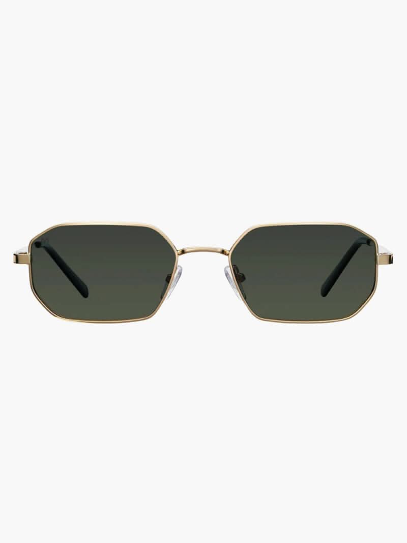 A woman wearing vintage-style gold polarised sunglasses on a sunny day out.