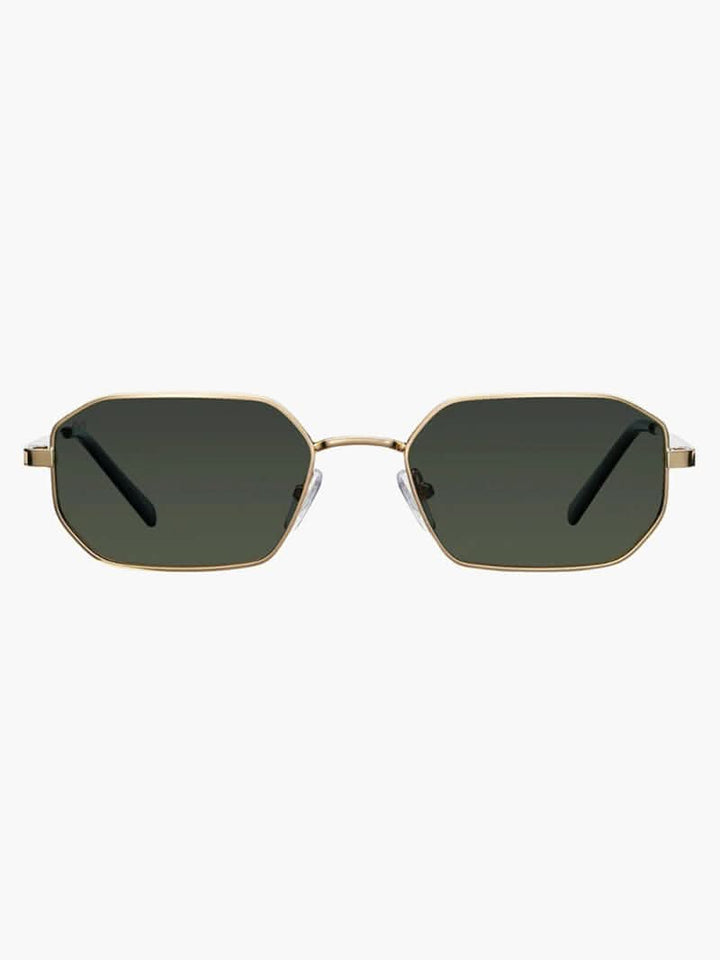 A woman wearing vintage-style gold polarised sunglasses on a sunny day out.