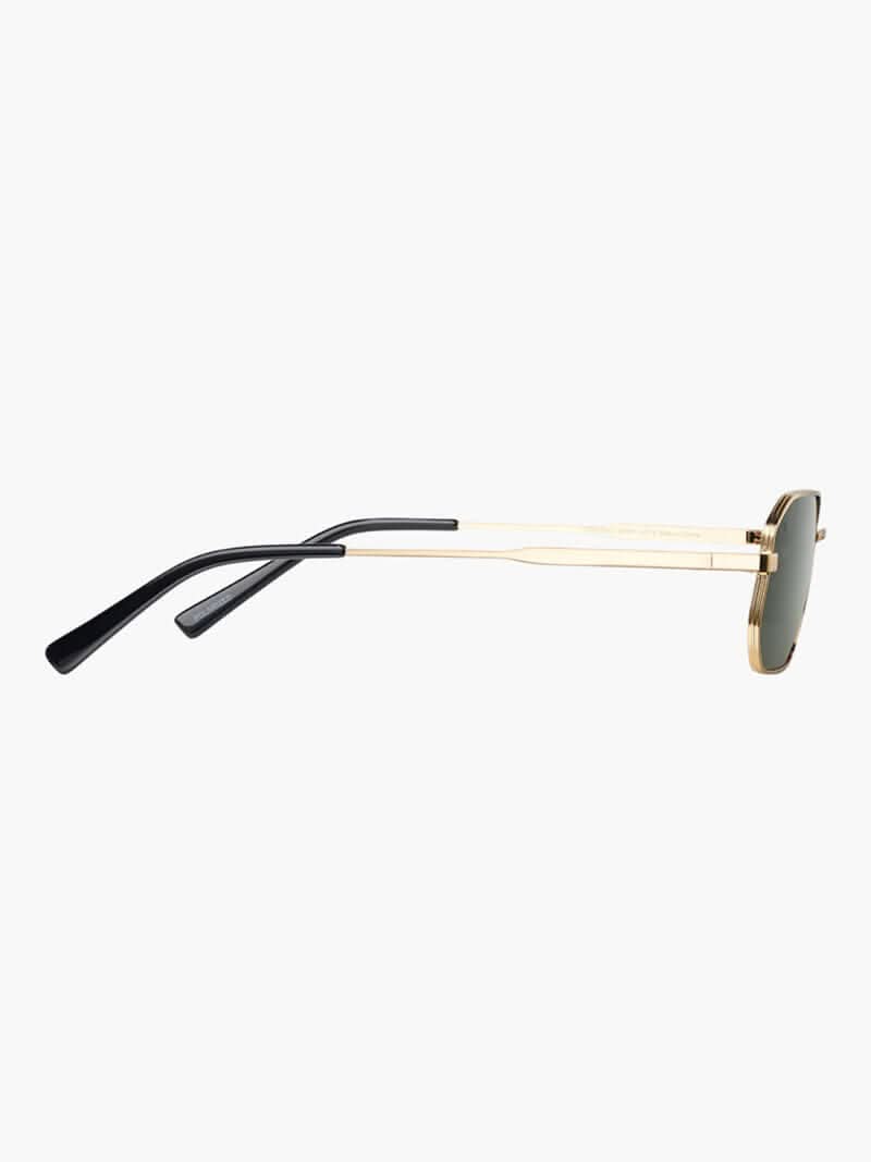 A woman wearing vintage-style gold polarised sunglasses on a sunny day out.