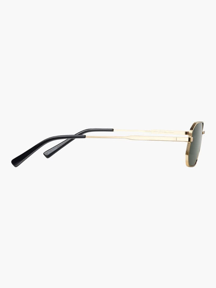 A woman wearing vintage-style gold polarised sunglasses on a sunny day out.