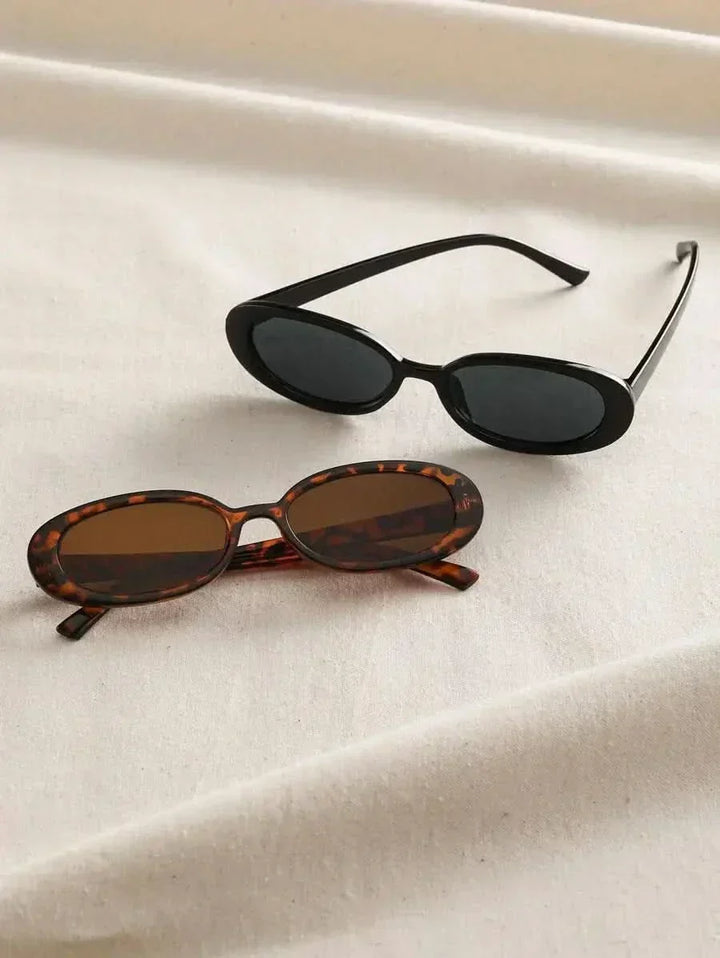 A woman wearing oval retro sunglasses while out shopping on a sunny day.