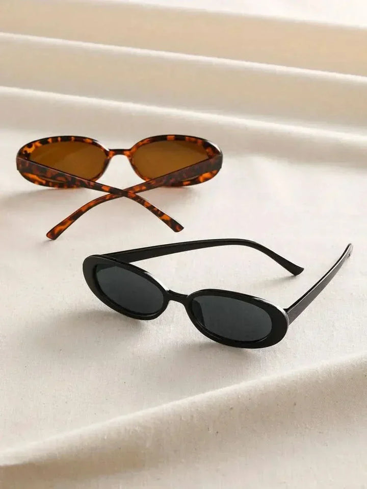 A woman wearing oval retro sunglasses while out shopping on a sunny day.