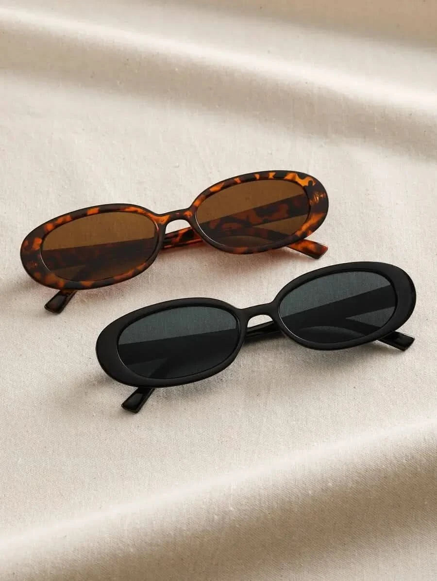 A woman wearing oval retro sunglasses while out shopping on a sunny day.