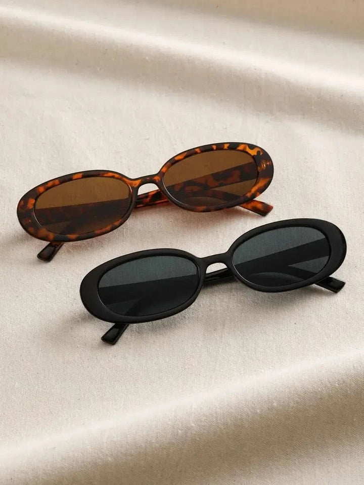 A woman wearing oval retro sunglasses while out shopping on a sunny day.