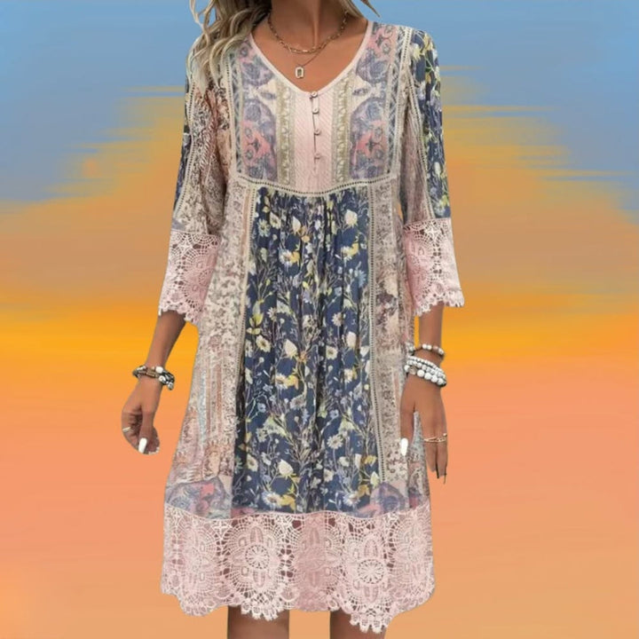 A woman wearing the Cindy romantic boho midi dress with scalloped trim and a floral patchwork print.