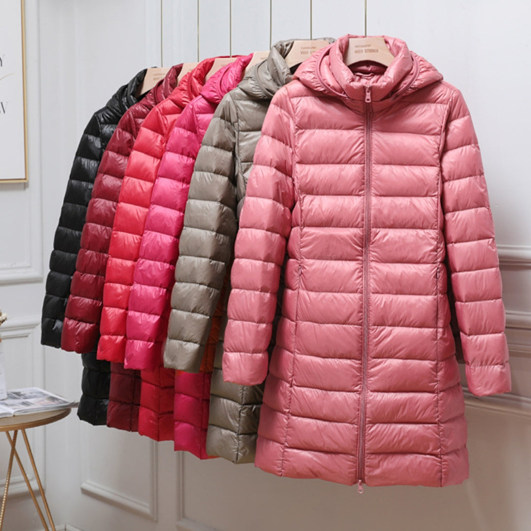 A rail of ultra-light padded hooded coats in pink, red, khaki and black, knee-skimming in length.