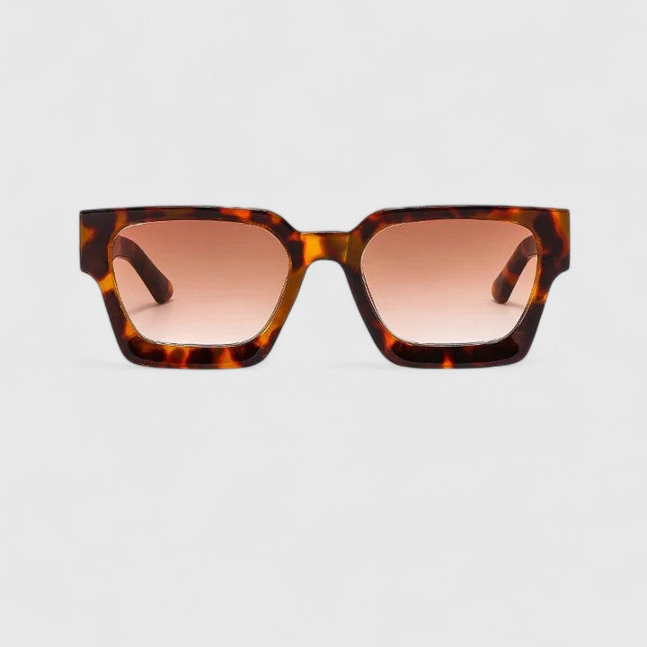 A woman out for the day wearing classic square sunglasses, relaxed and stylish in the sun.