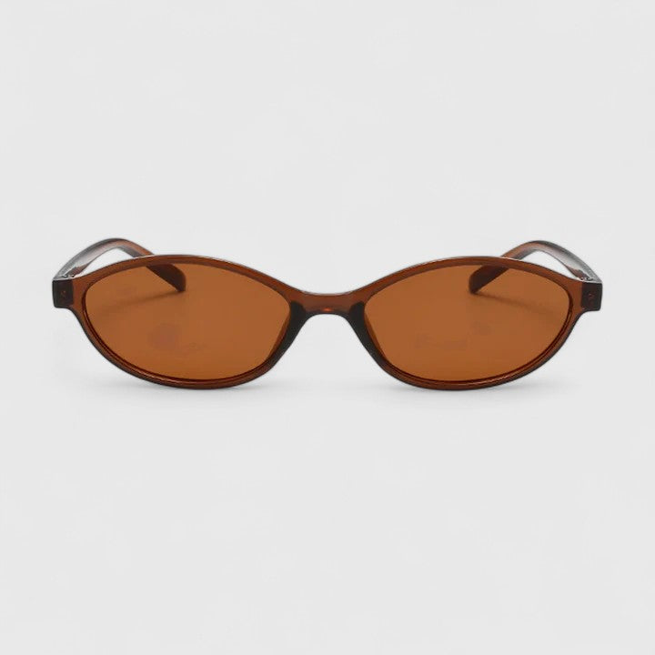A woman wearing retro oval cat-eye sunglasses on a sunny afternoon.