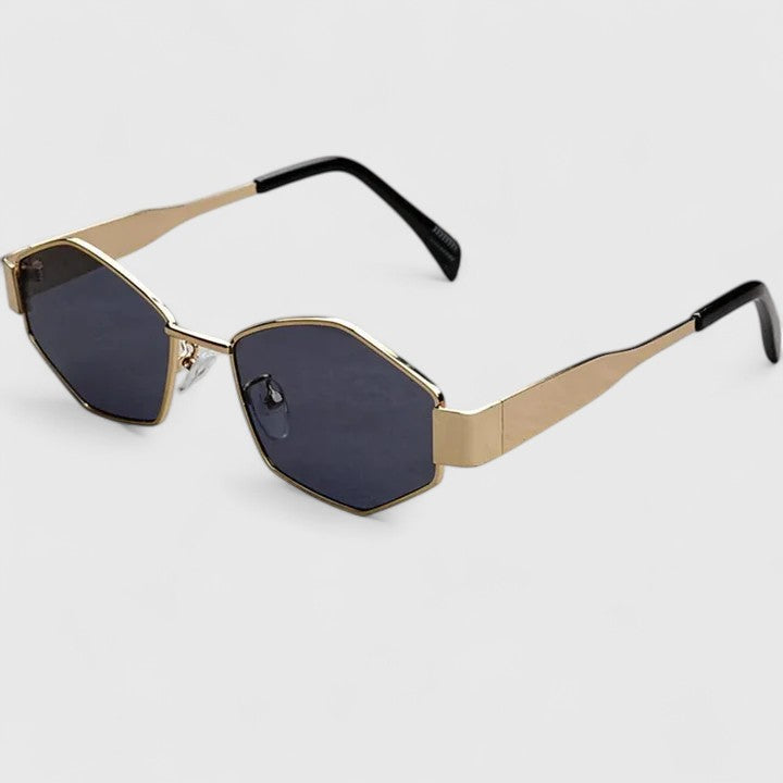 A woman wearing retro hexagonal metal-frame sunglasses on a sunny street.