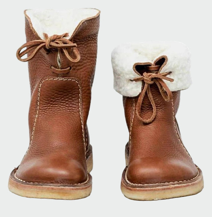 Woman wearing beige warm-lined winter boots on a cold day out.