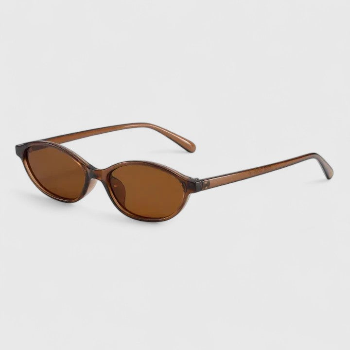 A woman wearing retro oval cat-eye sunglasses on a sunny afternoon.